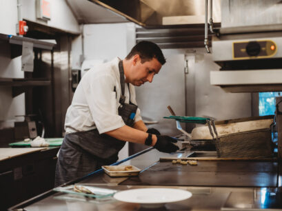 Chef cooking on stovetop.