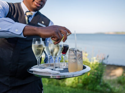 Waiter carrying drinks.
