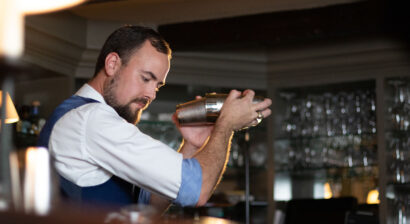 Waiter shaking drink.